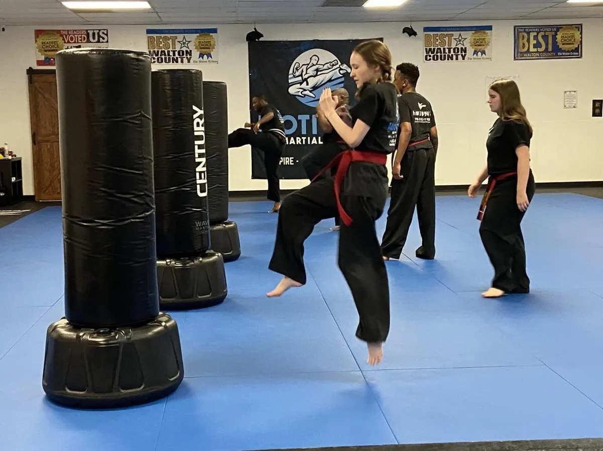 Students practicing kicks on the bags